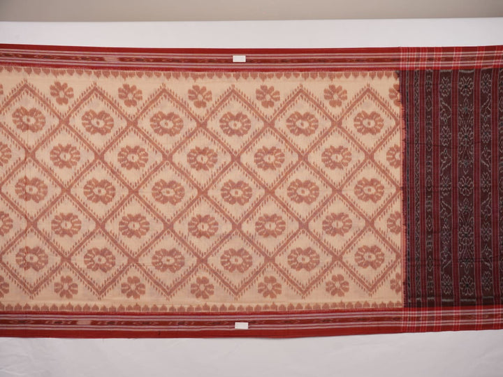 Traditional styling of a cream and rust Sambalpuri cotton saree draped on a model for a classic look.