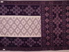 Elegantly draped red and violet Sambalpuri cotton saree with traditional motifs.