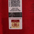Close-up of green Sambalpuri silk saree fabric showing intricate woven motif texture and red thread details.