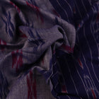 Blue Sambalpuri cotton saree with motifs, gracefully draped.