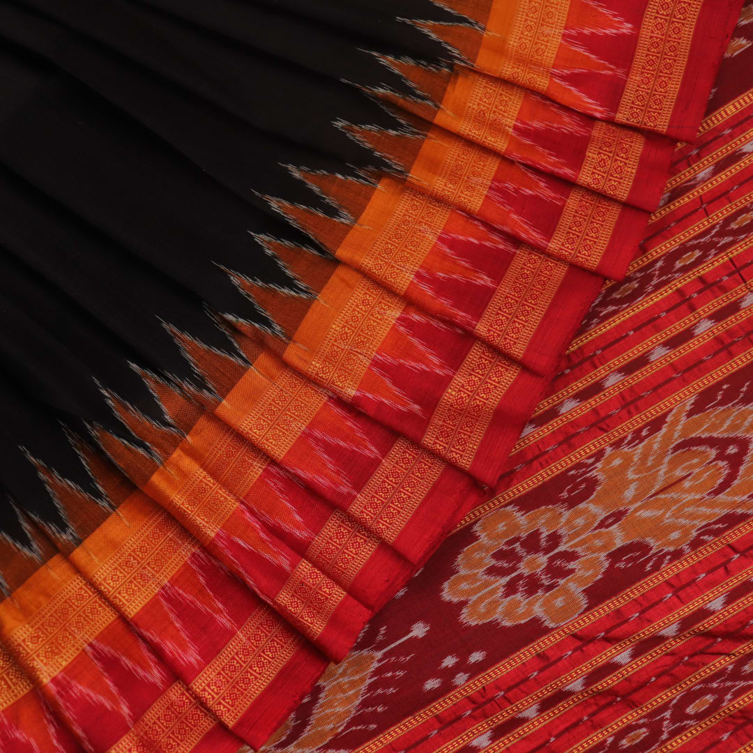 Black Khandua silk saree styled; showcases the drape and overall appearance, highlighting the red butta pattern.