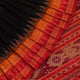 Black Khandua silk saree styled; showcases the drape and overall appearance, highlighting the red butta pattern.