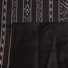 Close-up of the plain, slubby texture of a handwoven green and black Tussar silk saree.