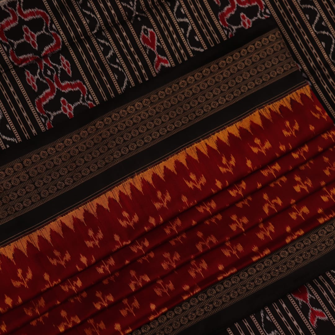 Close-up showing the fine silk texture and intricate motifs of the Sambalpuri saree