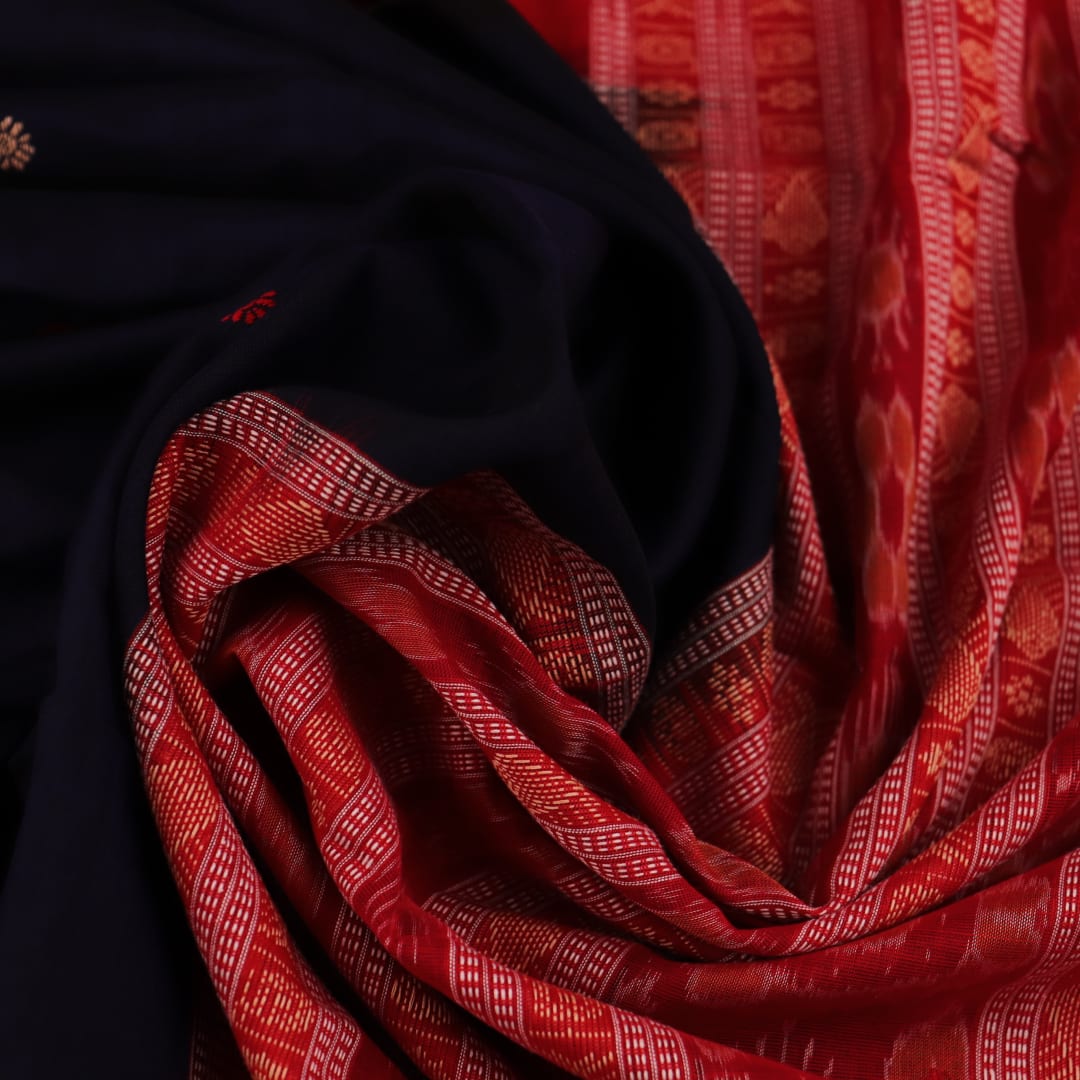 A full-length view of a vibrant blue Sambalpuri cotton saree with Pasapalli pattern and a contrasting red border.