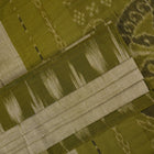 Full styling view of a model draped in a plain green Sambalpuri cotton saree with traditional accents.