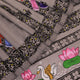 Close-up of grey silk Patachitra saree fabric showing hand-painted texture and intricate weave detail.