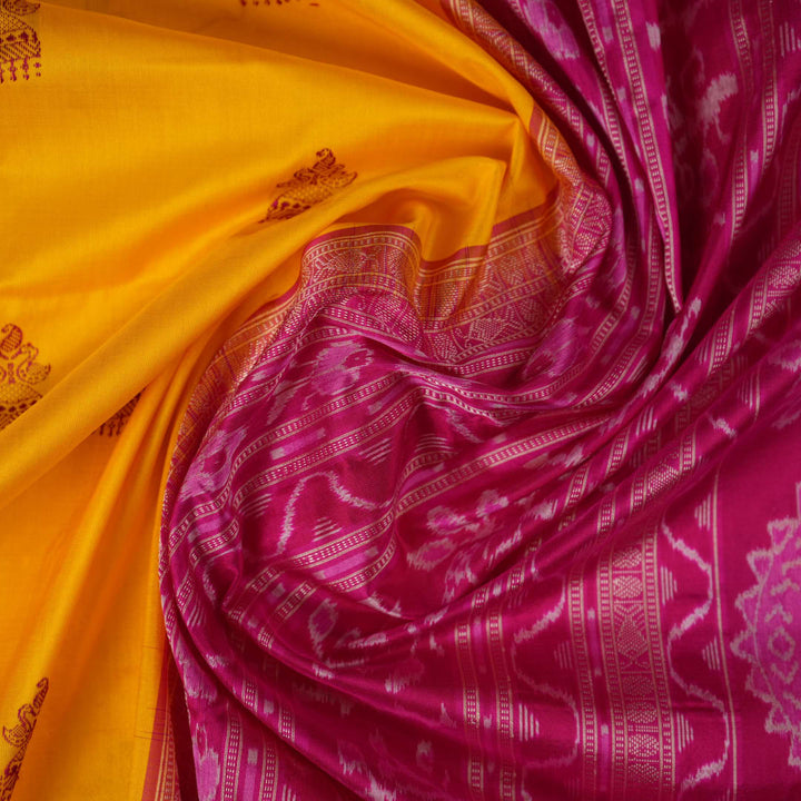Close-up of the Bomkai Silk Saree's yellow fabric, revealing its luxurious texture and handloom weave.