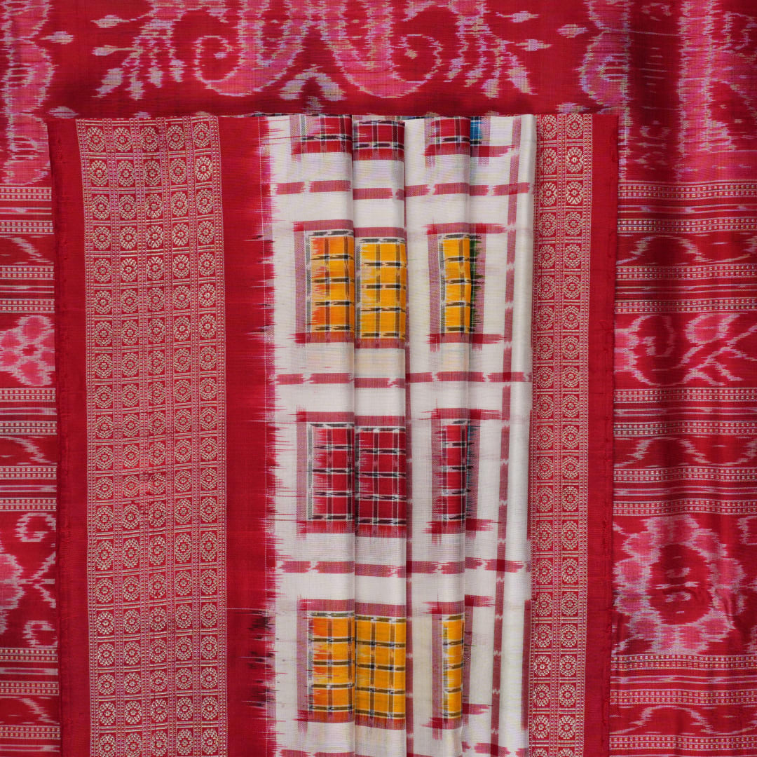 Close-up of the luxurious white Sambalpuri silk saree fabric, highlighting its rich texture and weave.