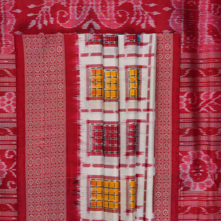 Close-up of the luxurious white Sambalpuri silk saree fabric, highlighting its rich texture and weave.