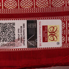 Close-up of grey Sambalpuri silk saree fabric showing intricate woven motifs and texture.