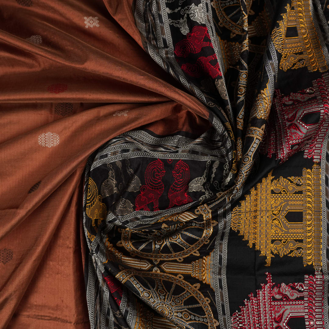 Extreme close-up of brown Bomkai silk saree fabric, revealing rich weave texture and luxurious feel.