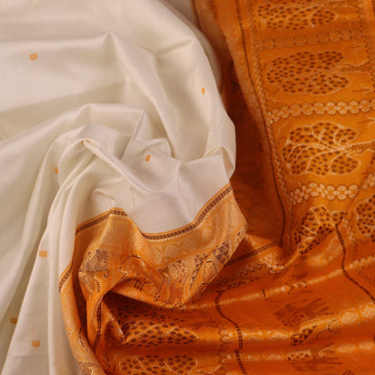Close-up of Bomkai silk saree fabric texture in white with yellow butta pattern.