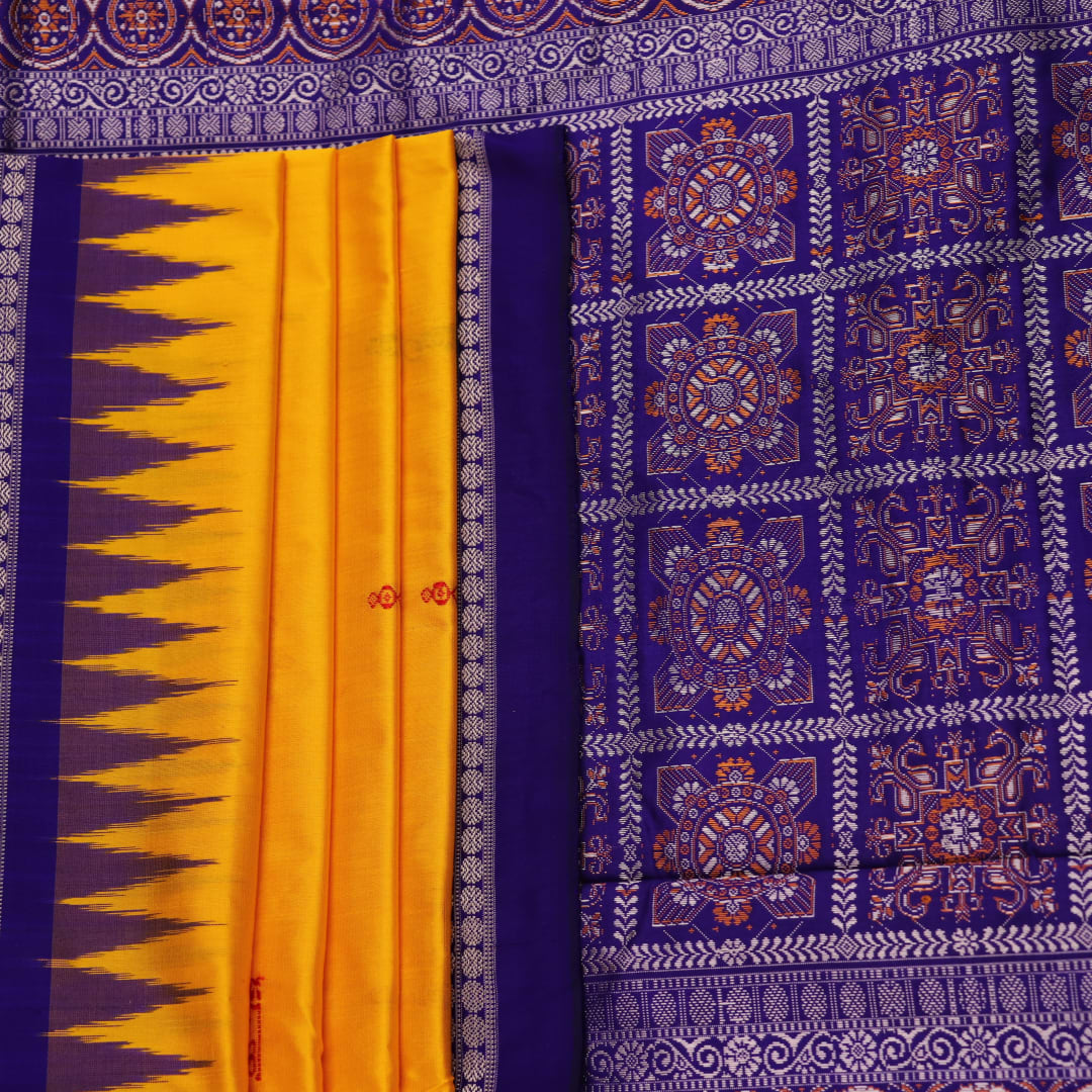 Close-up showcasing the yellow and blue butta pattern on the silk Bomkai saree fabric.