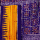 Close-up showcasing the yellow and blue butta pattern on the silk Bomkai saree fabric.