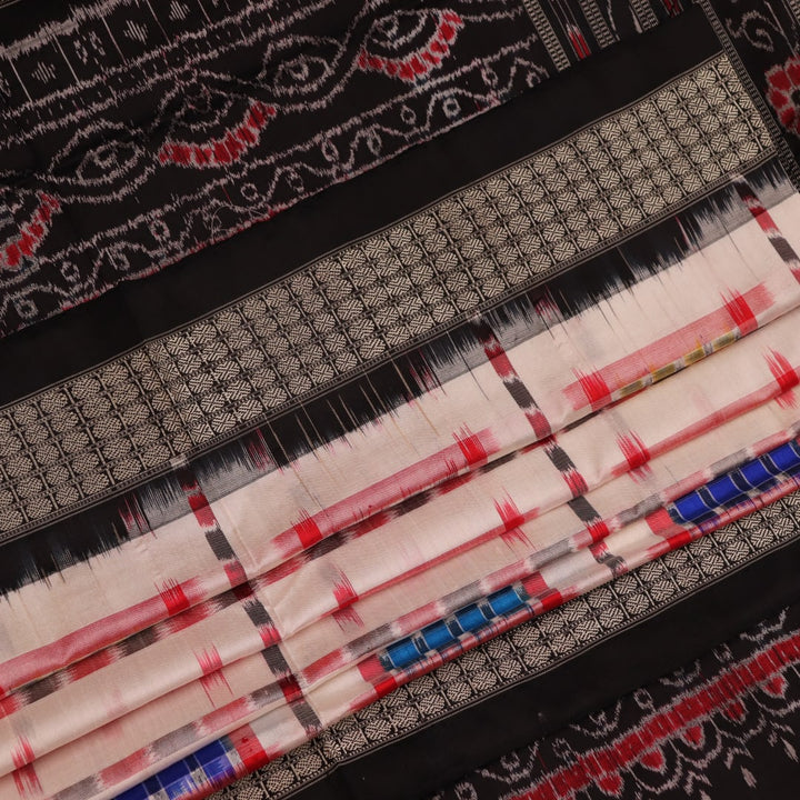 Close-up of white silk handloom saree with black Sambalpuri motifs