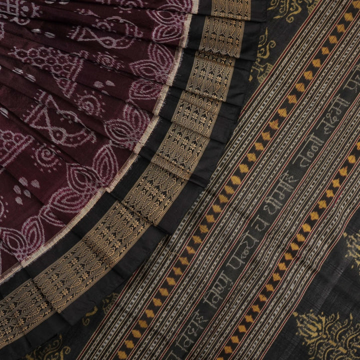 Micro close-up of the maroon Sambalpuri silk fabric, revealing its luxurious texture and handloom weave.