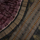 Micro close-up of the maroon Sambalpuri silk fabric, revealing its luxurious texture and handloom weave.