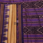 Woman draped in a cream and blue Khandua silk saree with butta pattern, showcasing the elegant drape and styling.