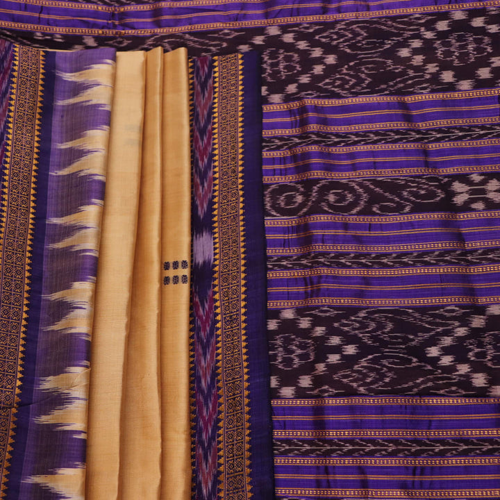 Woman draped in a cream and blue Khandua silk saree with butta pattern, showcasing the elegant drape and styling.