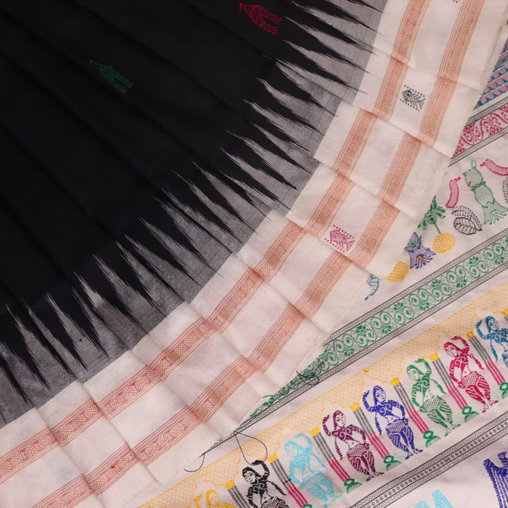 Close-up texture of black and white Bomkai silk saree with butta pattern.