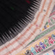 Close-up texture of black and white Bomkai silk saree with butta pattern.