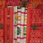 Model styled in a white and red Khandua silk saree showcasing its elegant fall and traditional Odia motifs.