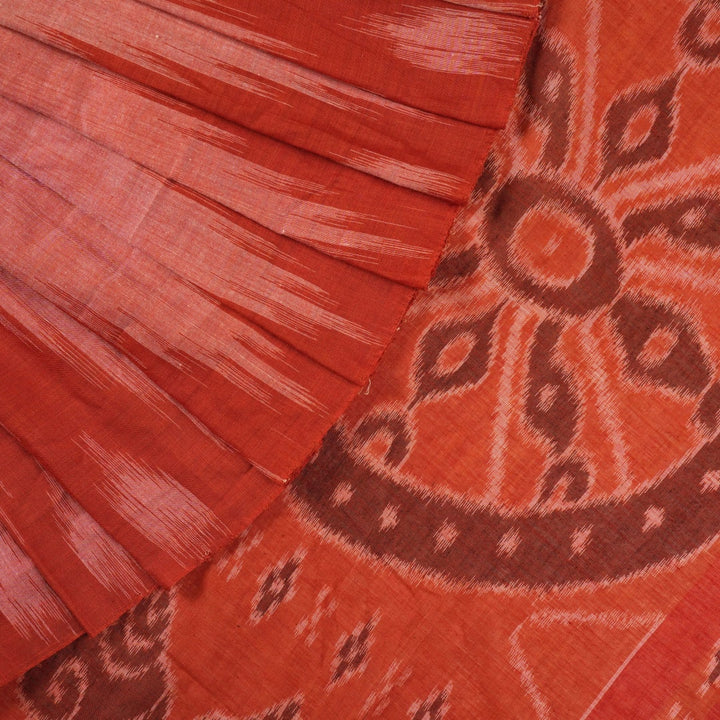 Professional styling view of a rust Sambalpuri cotton saree draped on a model for an elegant ethnic look.