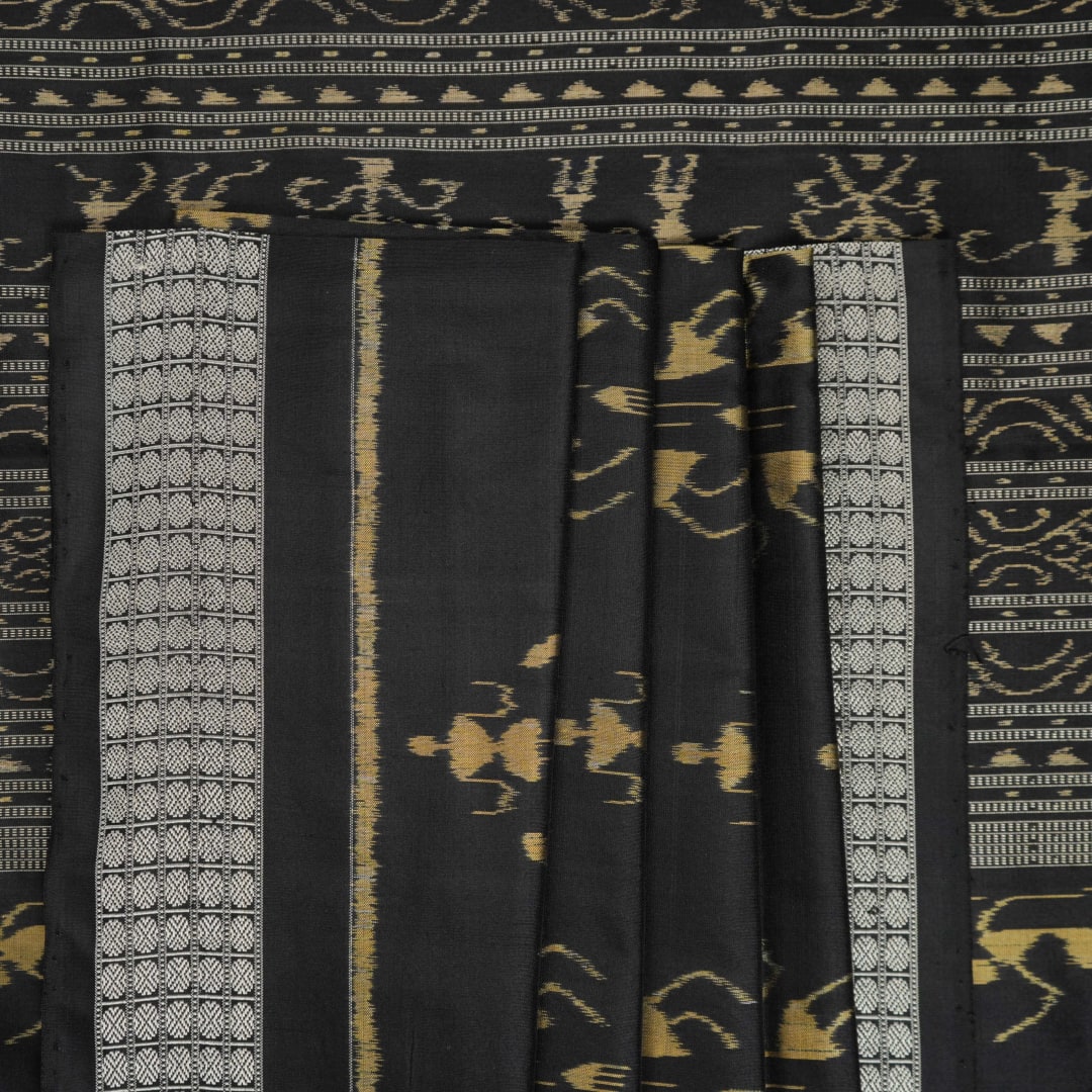 Close-up of the lustrous black Sambalpuri silk fabric, revealing its luxurious texture and fine weave.