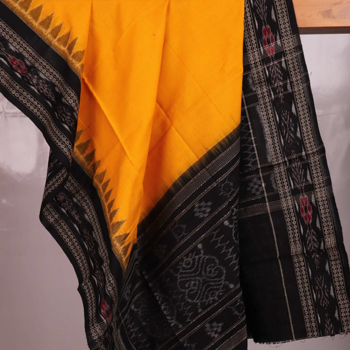 Yellow and black Sambalpuri cotton dupatta draped on a woman