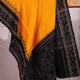 Yellow and black Sambalpuri cotton dupatta draped on a woman