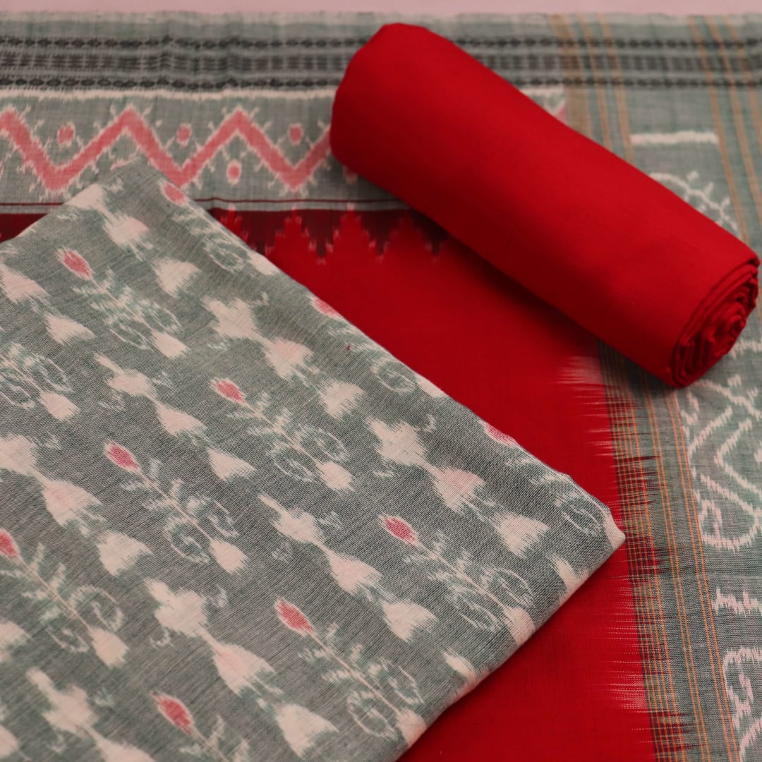 Close-up of a blouse piece in green and red cotton Sambalpuri fabric with motif patterns.