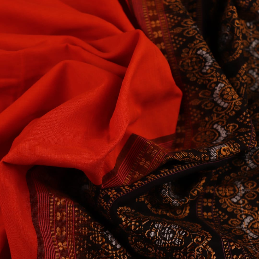 Full view of a Bomkai cotton saree in orange with black butta pattern