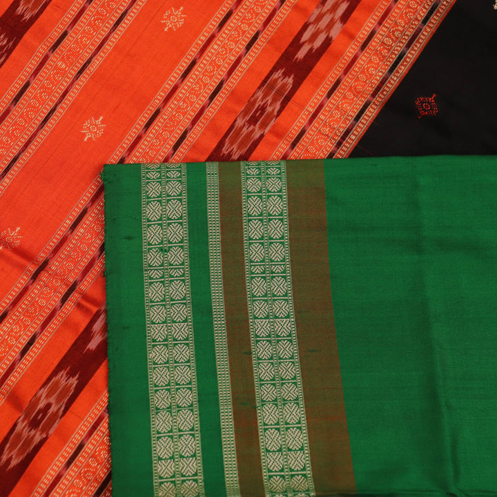 Close-up view of black silk Bomkai saree fabric showcasing its intricate butta pattern.