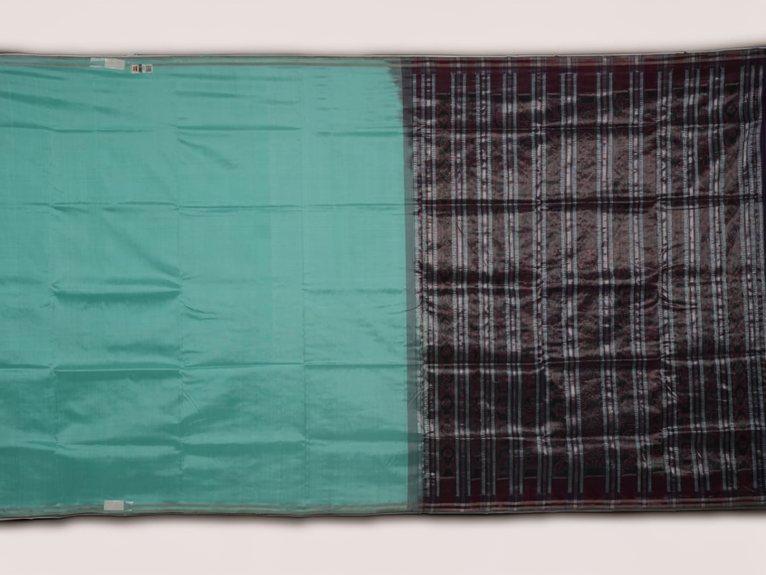 Ultra close-up of the luxurious green Sambalpuri handloom silk weave, highlighting its smooth texture.