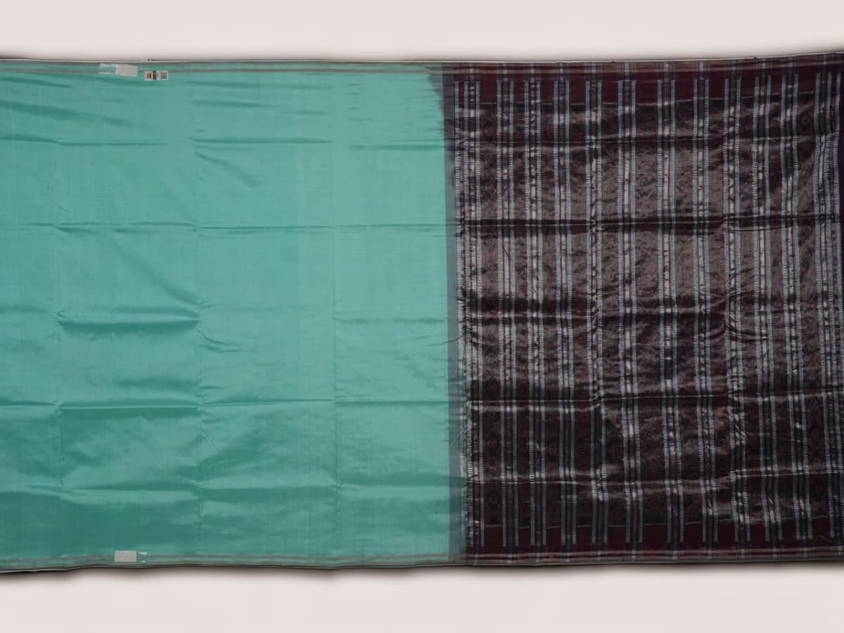 Ultra close-up of the luxurious green Sambalpuri handloom silk weave, highlighting its smooth texture.