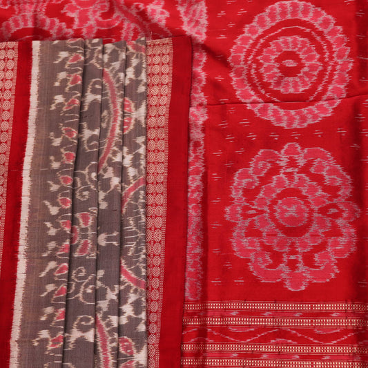Close-up of grey Sambalpuri silk saree fabric showing intricate motif texture.