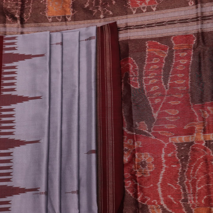 Close-up of grey and maroon Sambalpuri Silk Saree's butta pattern fabric texture.