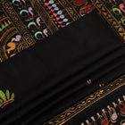 Close-up of the black silk Patachitra saree, showcasing the hand-painted fabric texture.