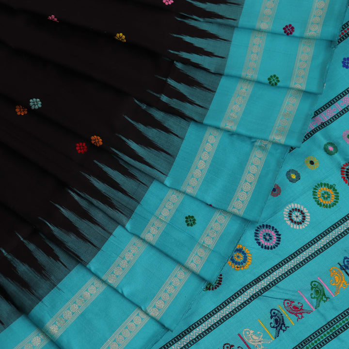 Close-up view of intricate butta pattern on the silk fabric of the black Dolabedi saree