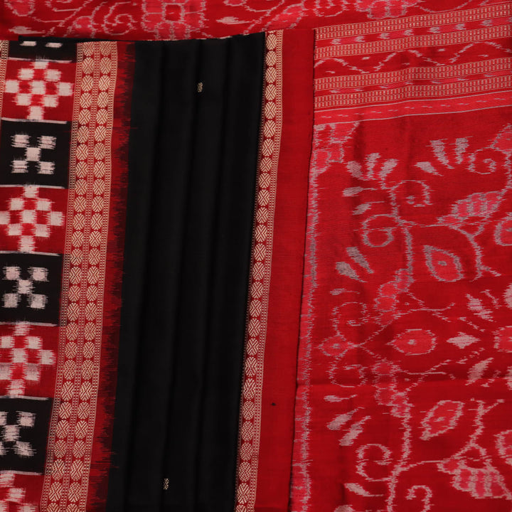 Close-up of black and red silk saree fabric with intricate Sambalpuri motifs