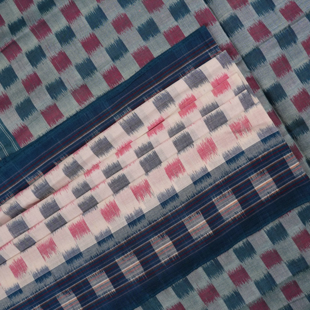 Styling view of a model draped in a white and blue Sambalpuri cotton saree with motif patterns