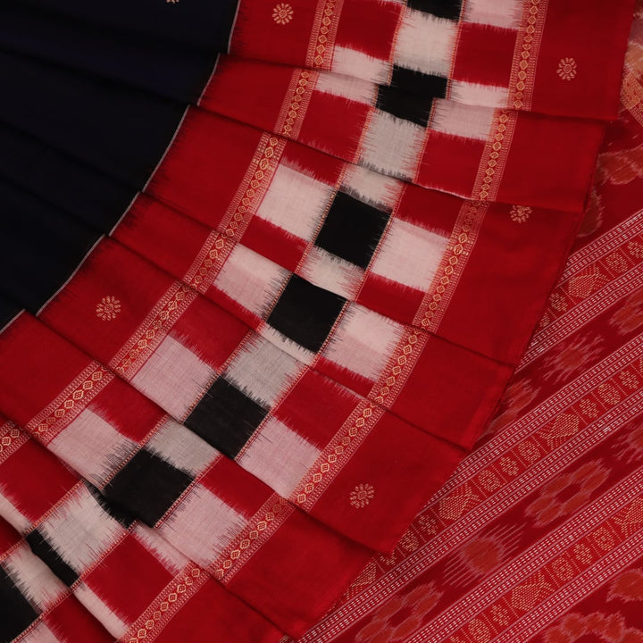 A full-length view of a vibrant blue Sambalpuri cotton saree with Pasapalli pattern and a contrasting red border.