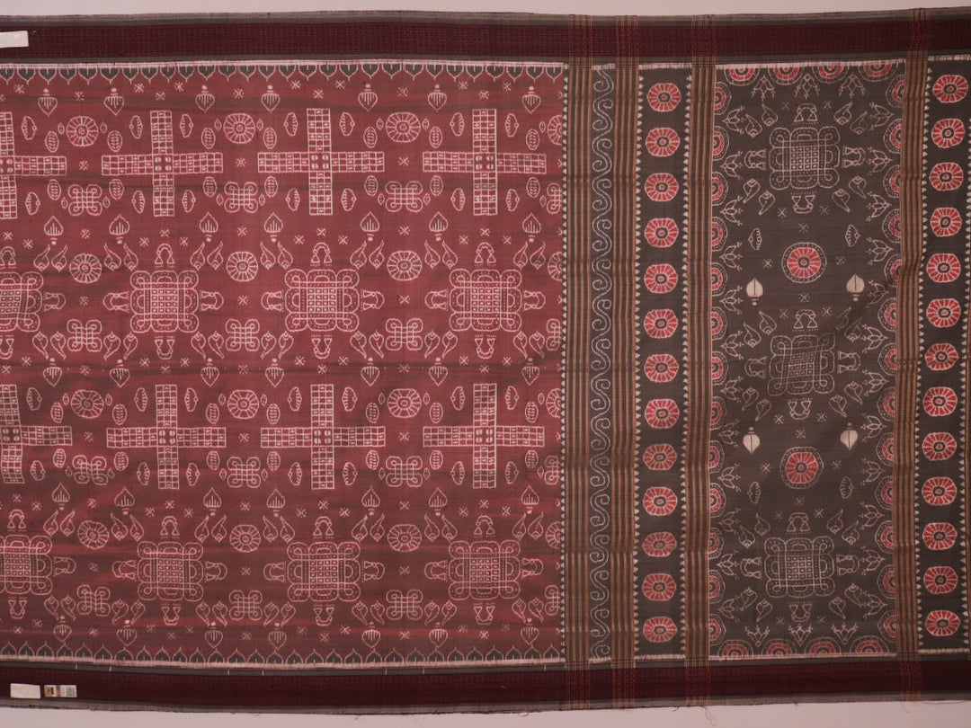 Close-up of a multicolored silk Sambalpuri saree fabric showing the intricate handloom texture and motifs.