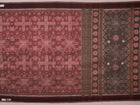 Close-up of a multicolored silk Sambalpuri saree fabric showing the intricate handloom texture and motifs.