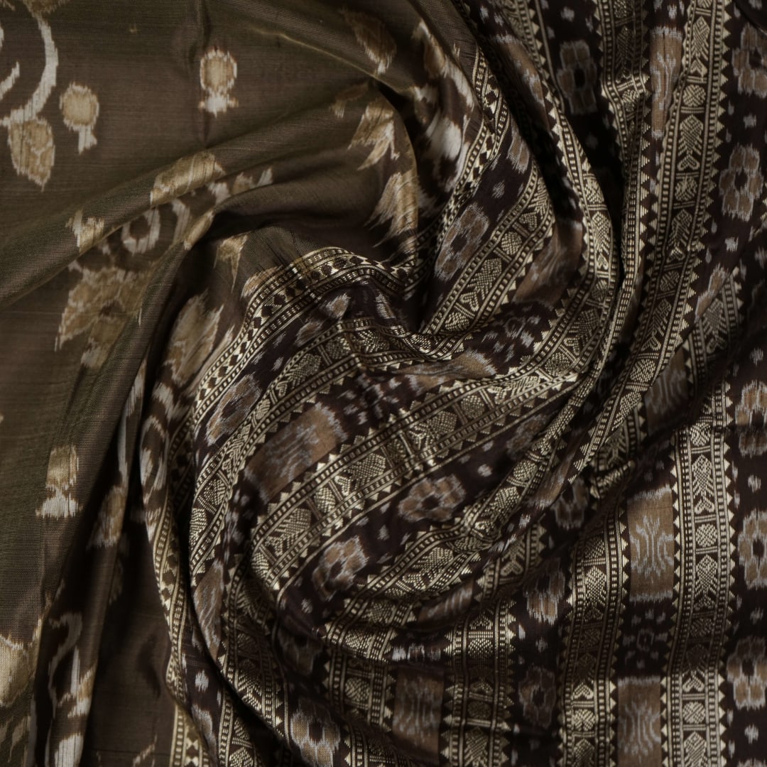 Close-up of the grey and black Sambalpuri Silk Saree fabric, highlighting its rich silk texture and weave.
