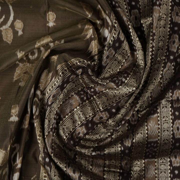 Close-up of the grey and black Sambalpuri Silk Saree fabric, highlighting its rich silk texture and weave.