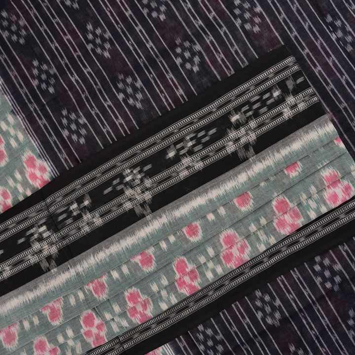 Model wearing a green and black Sambalpuri cotton saree showcasing traditional handloom drape and motifs.