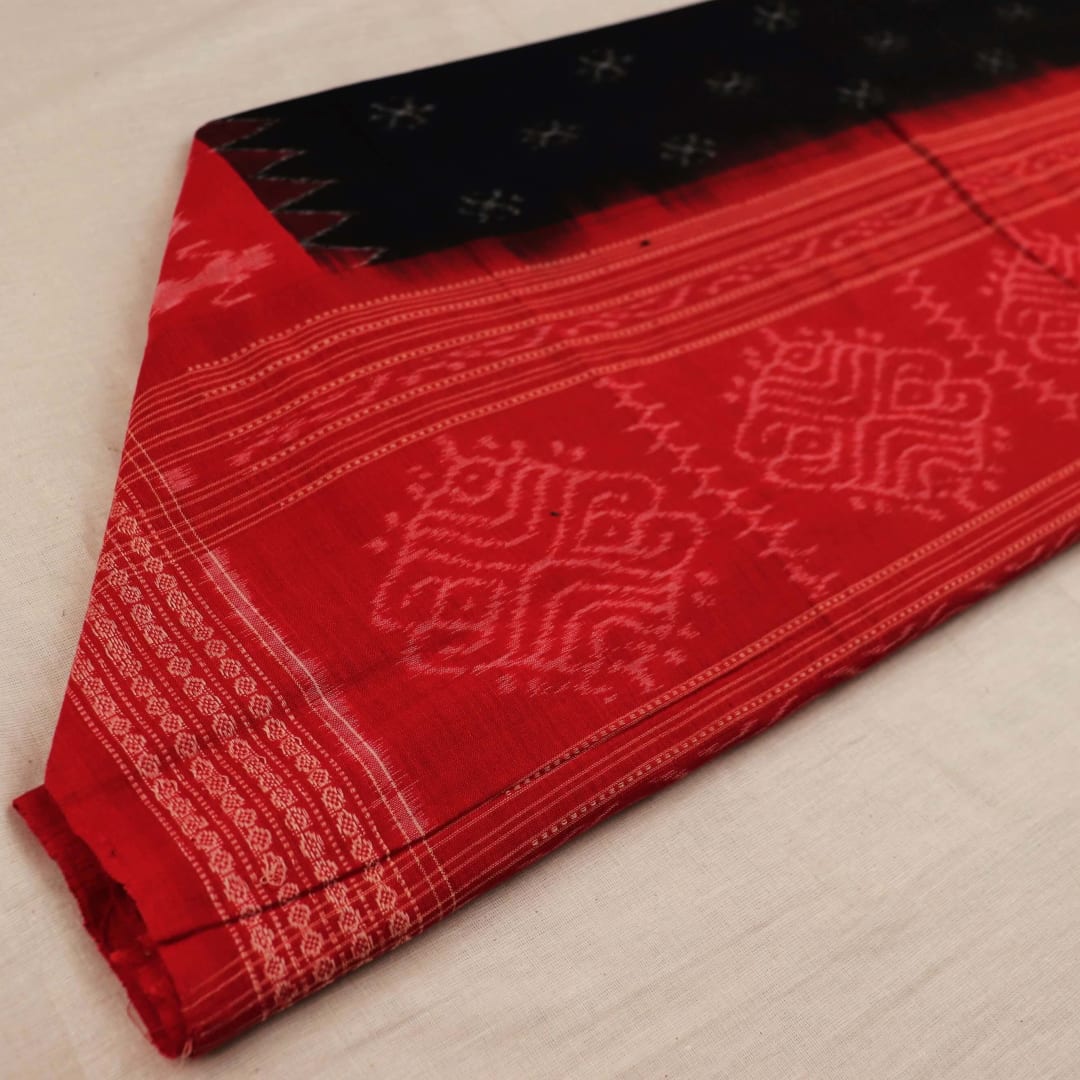 Close-up of a lightweight, black cotton Sambalpuri dupatta with red motifs in the border