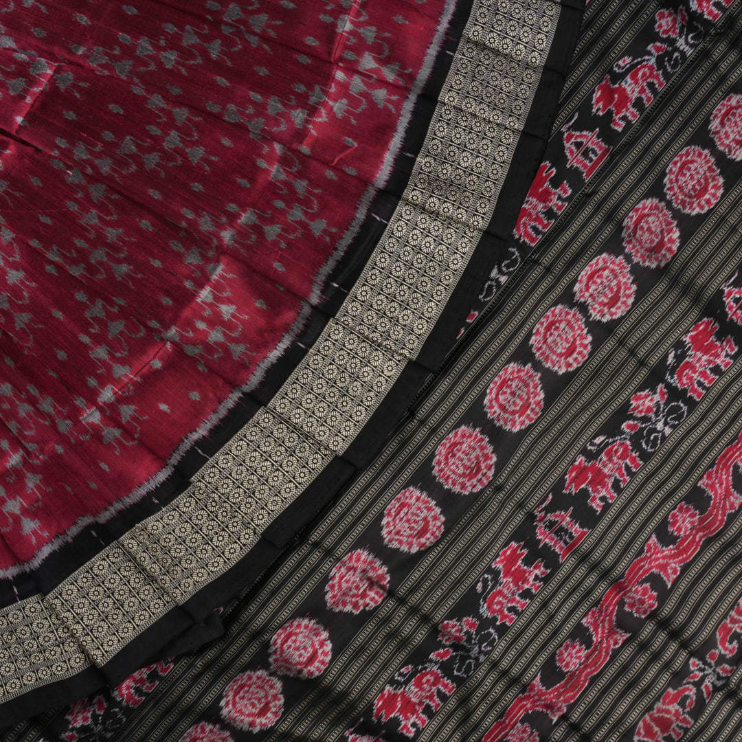 Detailed close-up of the maroon and black Sambalpuri silk saree's luxurious fabric texture and weave.